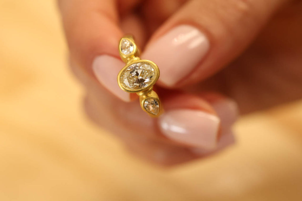 22K & 20K Brilliant Oval Diamond Ring with Diamond Pear Shape Side Stones