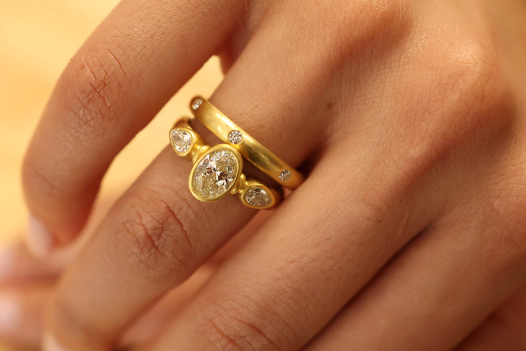 22K & 20K Brilliant Oval Diamond Ring with Diamond Pear Shape Side Stones