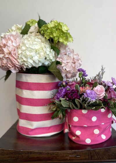 A Pink and White Theme Cloth Vases Over a Table