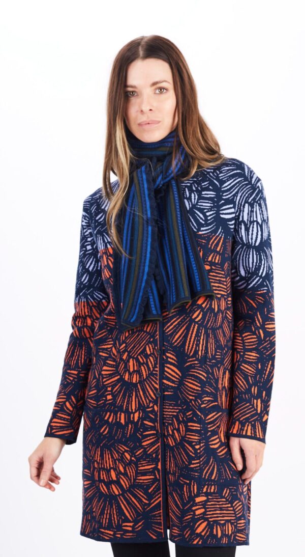 A Woman in a Navy Blue Coat With Orange and Blue Design