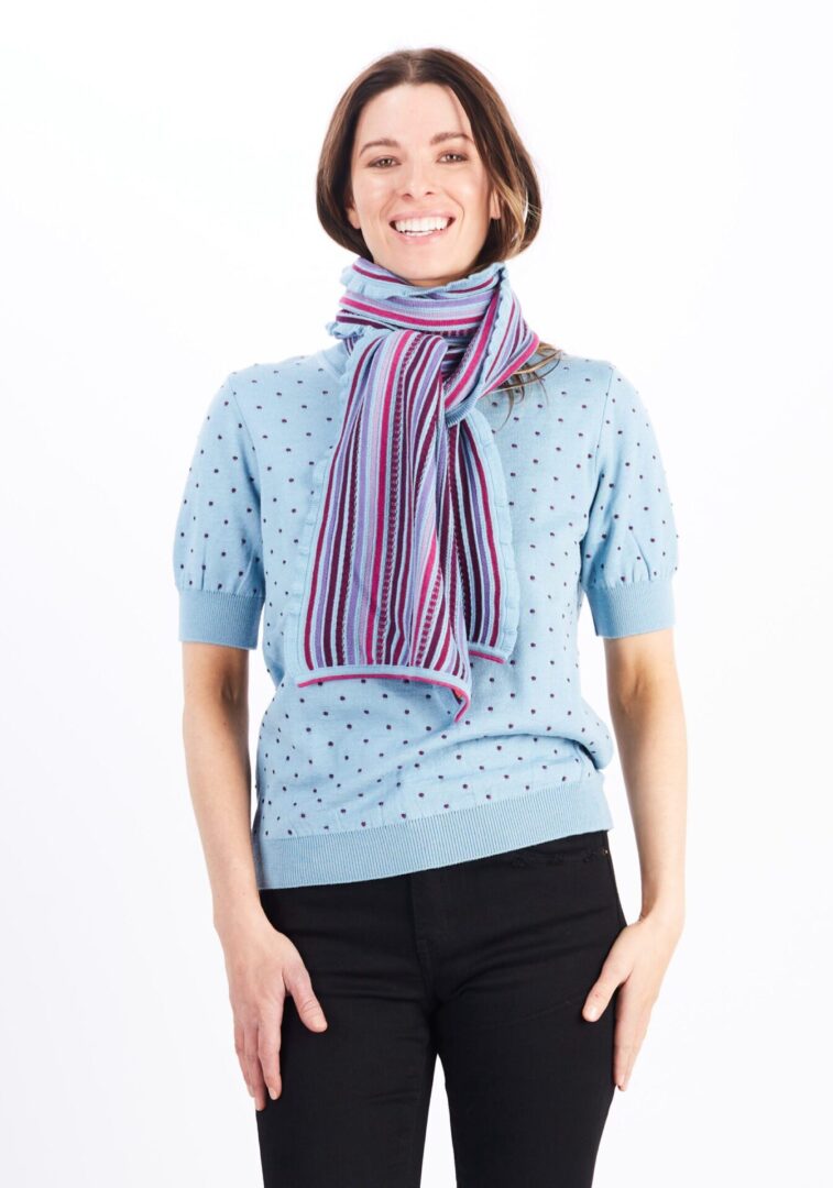 A Woman in a Blue Sweater With a Scarf