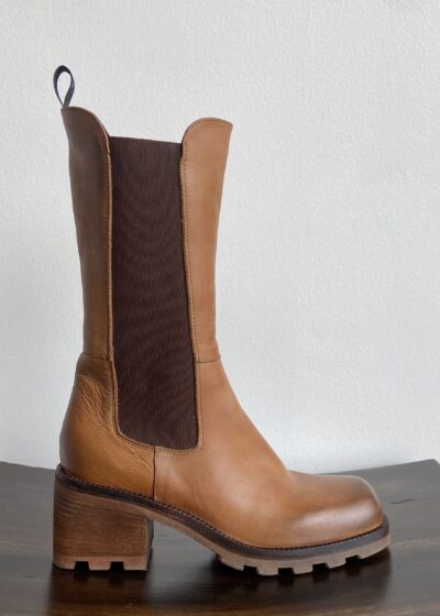 A Tan Boot With a Brown Color Strip