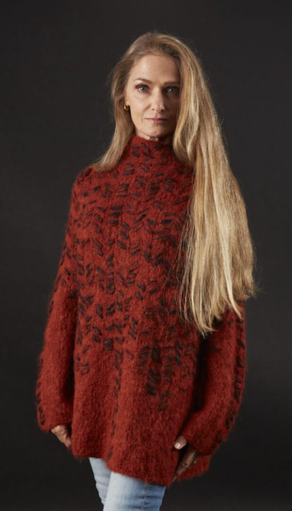 A Woman With Long Blond Hair and a Red Sweater