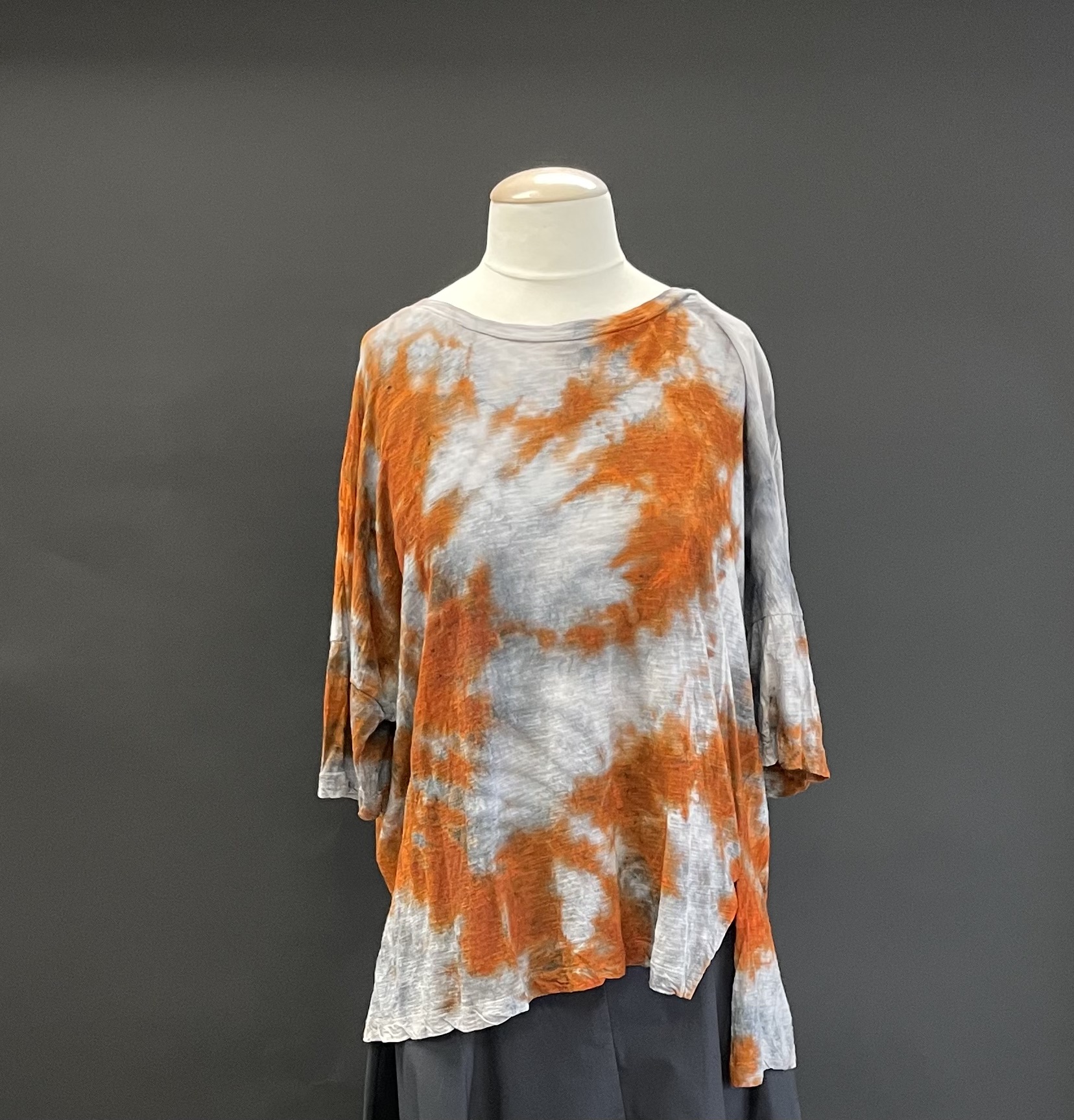 A White Color Shirt With an )Orange Strain