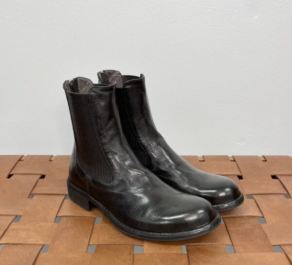 A Pair of Black Color Ankle Boots on a Mat