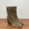 A Pair of Ankle Length Boots With Heels Placed on a Mat