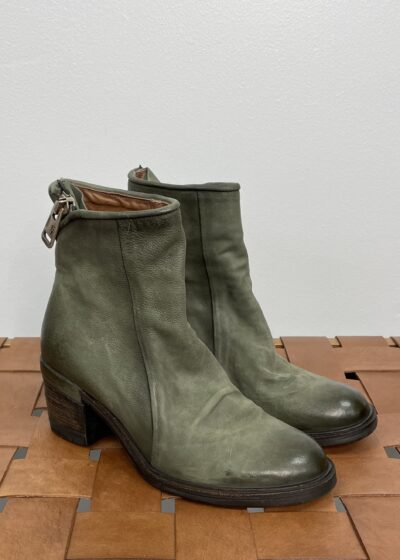 A Pair of Olive Green Boots With a Back Zipper