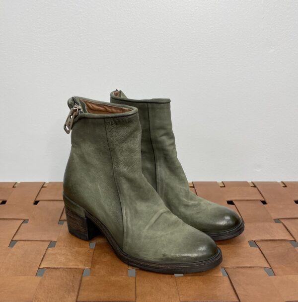 A Pair of Olive Green Boots With a Back Zipper