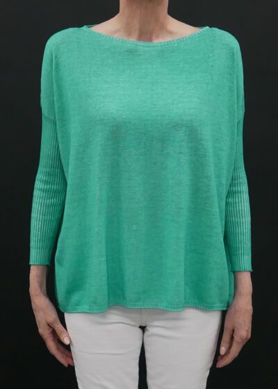 A Woman in a Loose Green Color Sweater With Full Sleeves