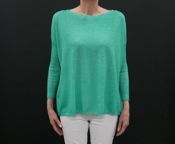 A Woman in a Loose Green Color Sweater With Full Sleeves