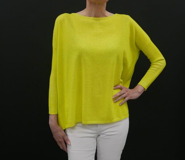 A yellow color top with a black background from front