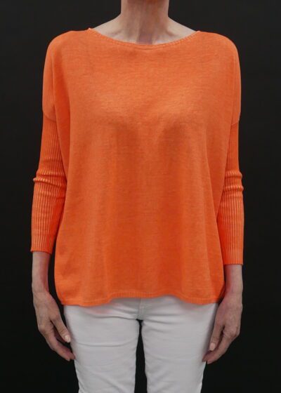 A Loose Orange Color Sweater With Full Sleeves