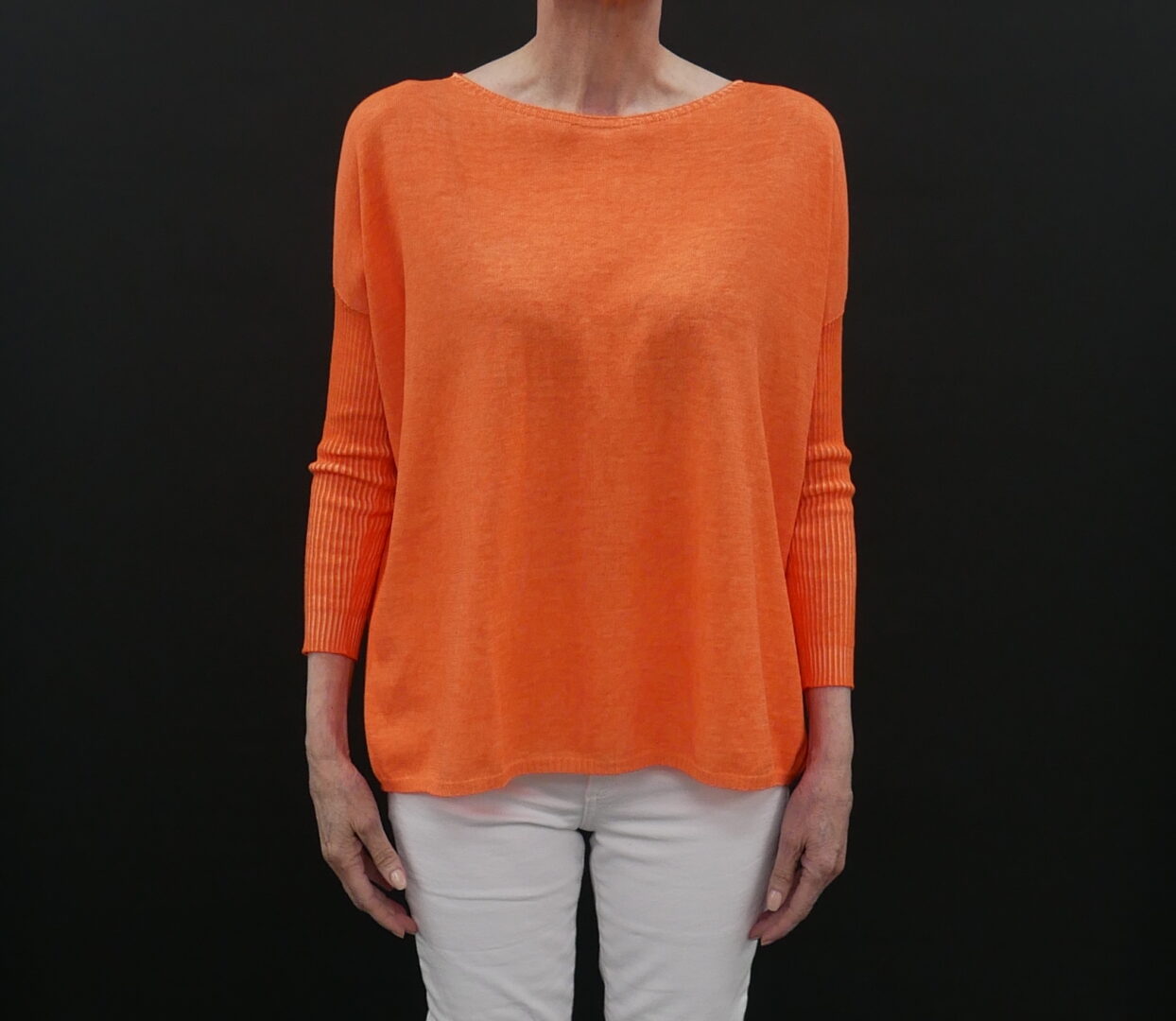 A Loose Orange Color Sweater With Full Sleeves