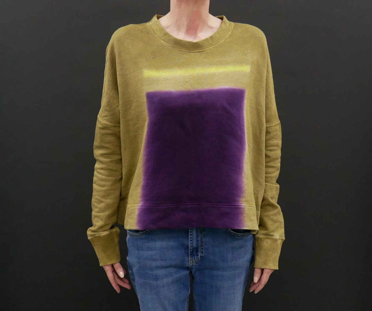 A Mustard Color Shirt With a Purple Strain