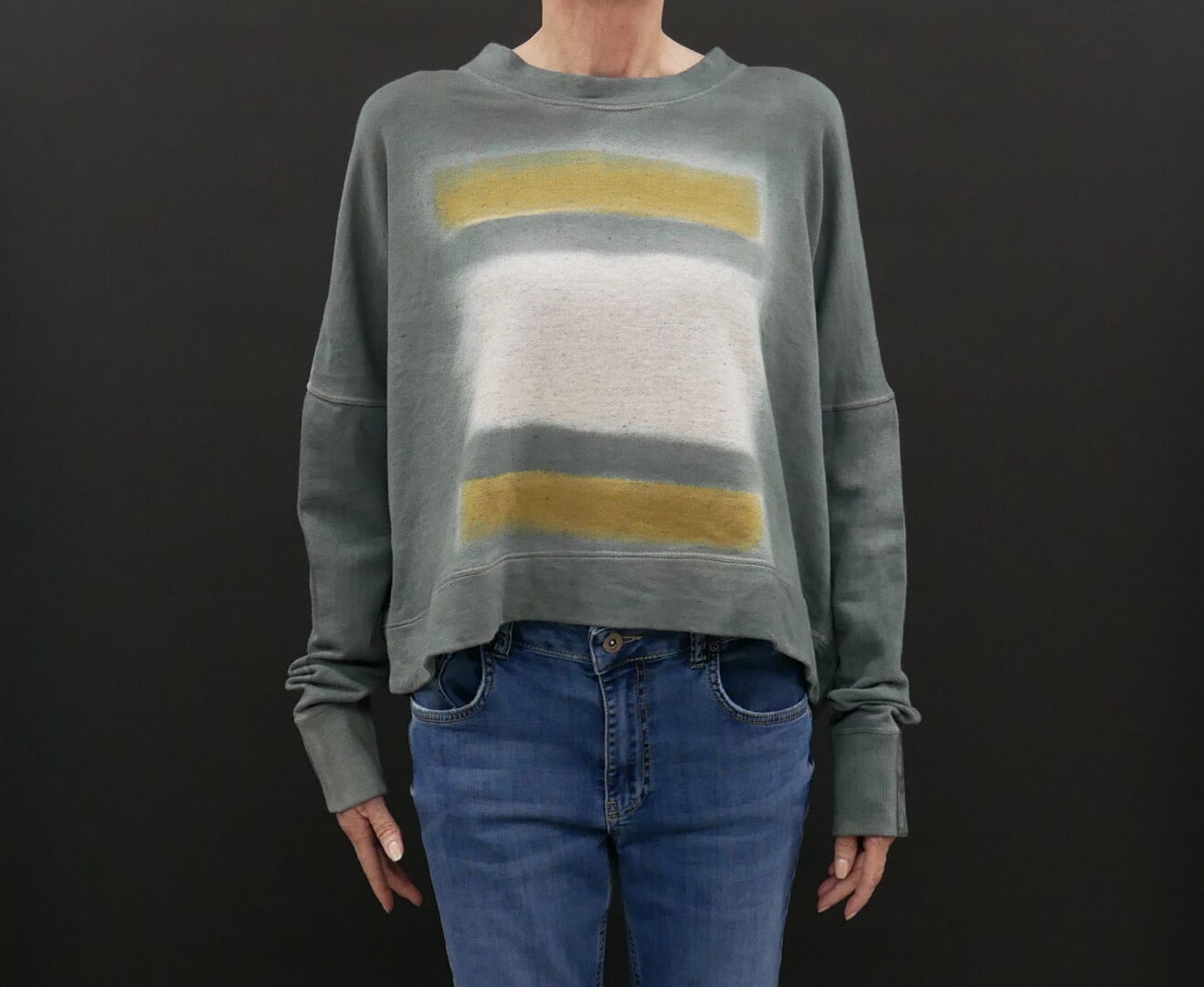 A Grey Color Sweater With White and Yellow Stripes